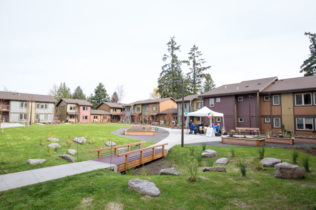 A photo a Bridge Meadows community, with buildings and a large open space in the center.