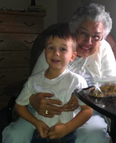 A Native grandmother and child pose together with smiles on their faces