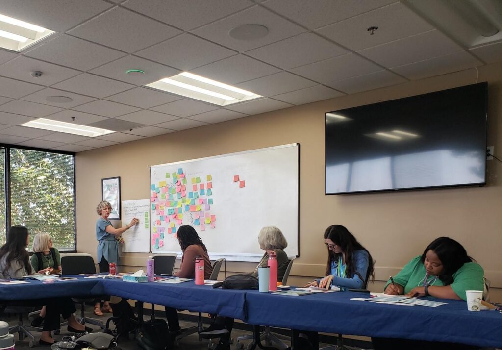 A diverse group of professional women brainstorm together in San Diego